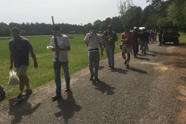 Fraternity men carrying shotguns for Annual IFC Skeet Shoot